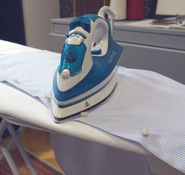 Ironing around the buttons of a shirt